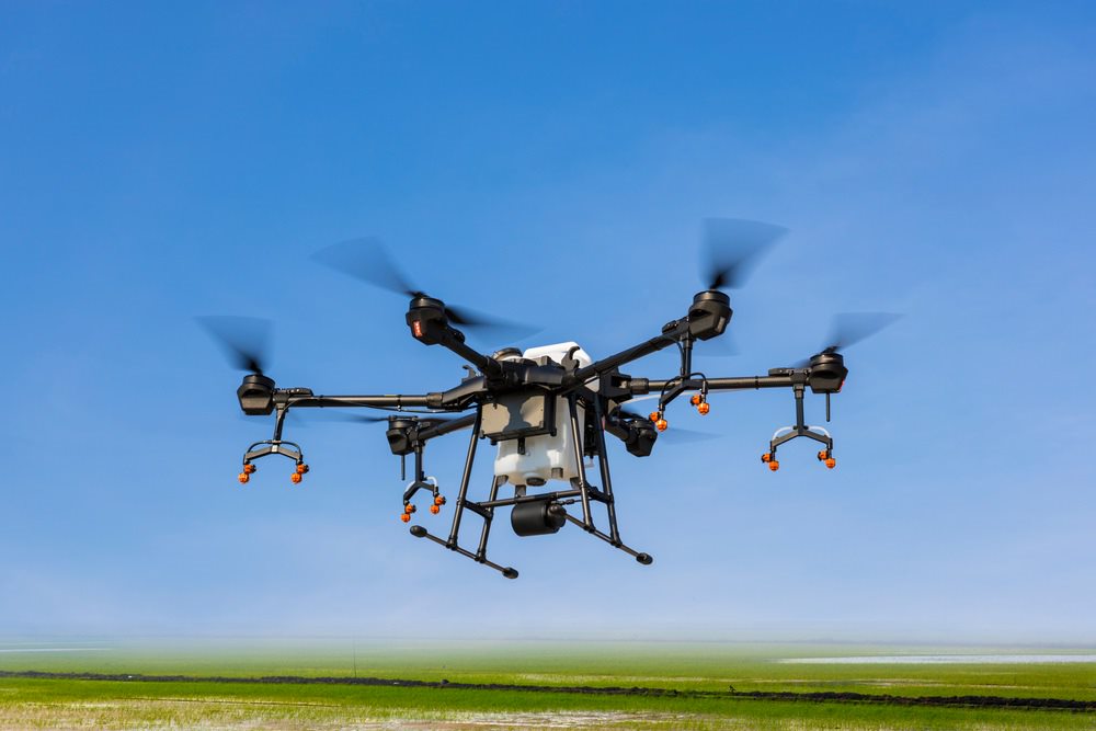Close up of a drone flying above a field