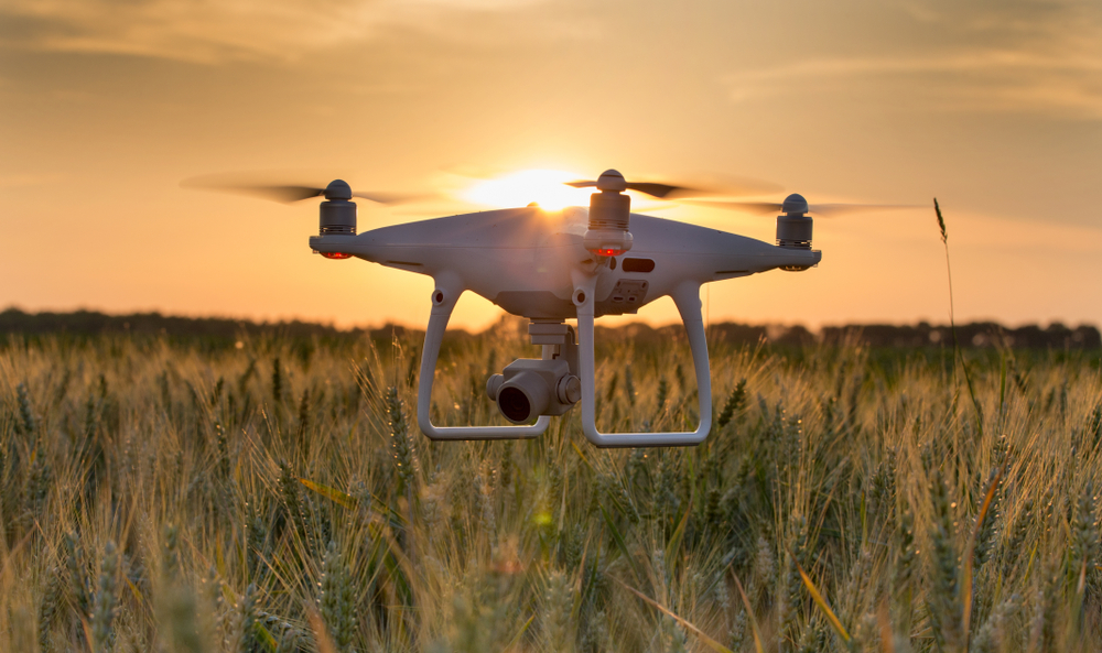 Drone hovering just above a field